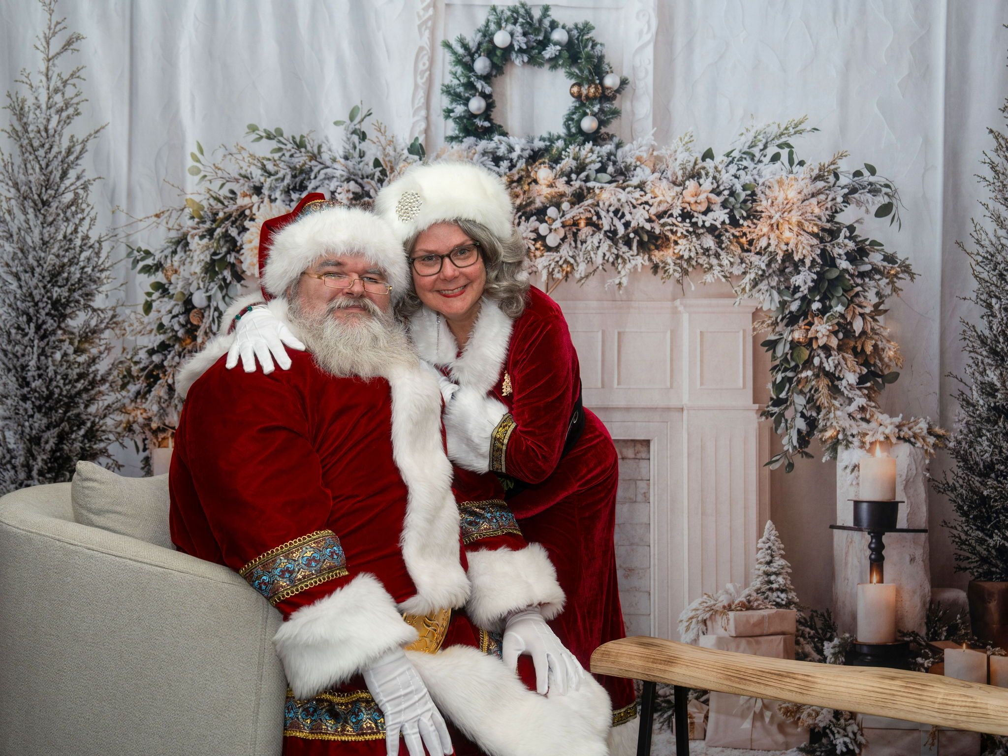 Santa and Mrs. Claus seated in a festive holiday setting